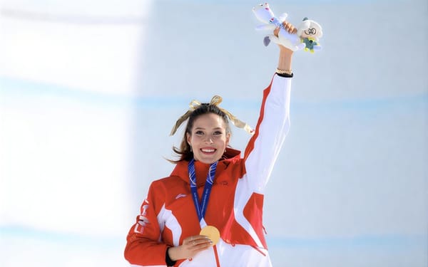 Eileen Gu holding medals